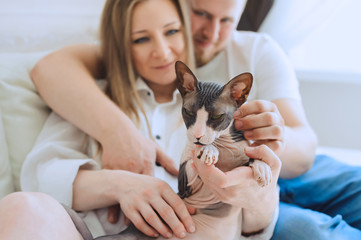 Loving man and woman with cat
