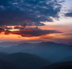 Fototapeta na wymiar Beautiful panoramic sunset in the mountains landscape. Dramatic evening sky.