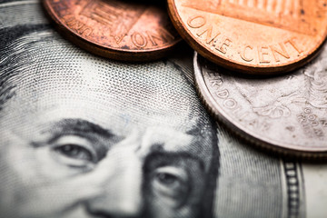 close-up shots in macro lens from one hundred dollars banknote and coins cents