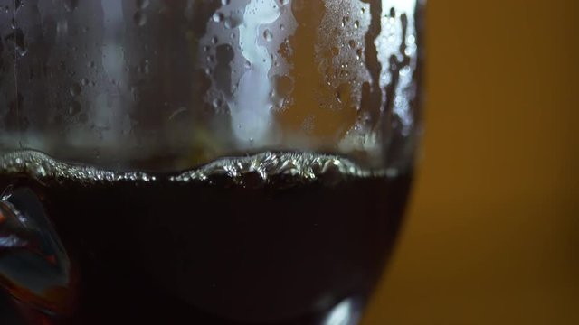 macro shot of freshy brewed coffee falling into a cup 4k