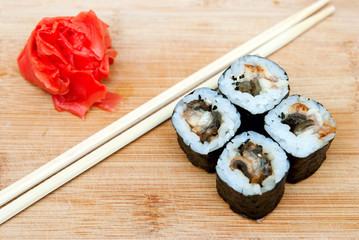 Roll with eel and wasabi on a wooden board