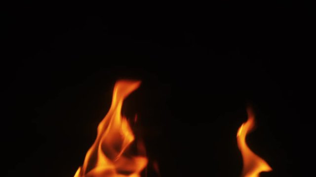 close up flames over blcak background in fireplace