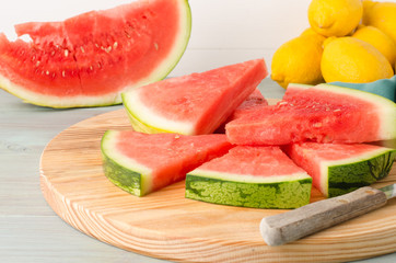 Slices of watermelon on a wood cutting board