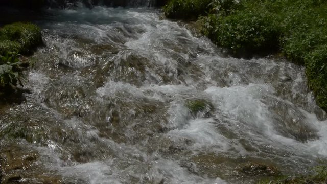 Close up of fast mountain river flowing over rocks