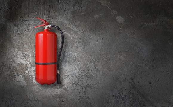 fire extinguisher on gray wall