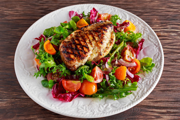 Grilled Chicken Breast fillet with fresh tomatoes vegetables salad. concept healthy food.