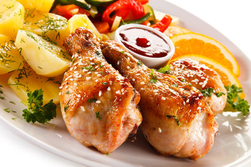 Grilled chicken legs with boiled potatoes and vegetables 