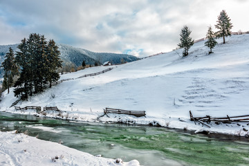 river through the village in winter