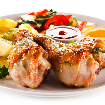 Grilled chicken legs with boiled potatoes and vegetables 