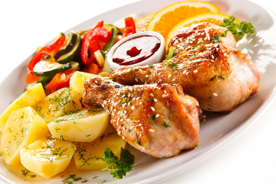 Grilled chicken legs with boiled potatoes and vegetables 