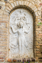Fototapeta na wymiar Bas relief representing the Virgin Mary surrounded by angels.