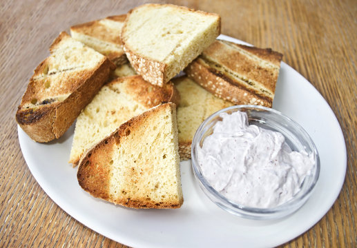 greek bread with olive oil and yoghurt sauce on wooden table