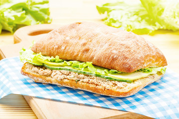 Large ciabatta sandwich with tuna, green, apple and cucumber