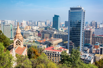 View of downtown Santiago, Chile with a church and statue in the foreground