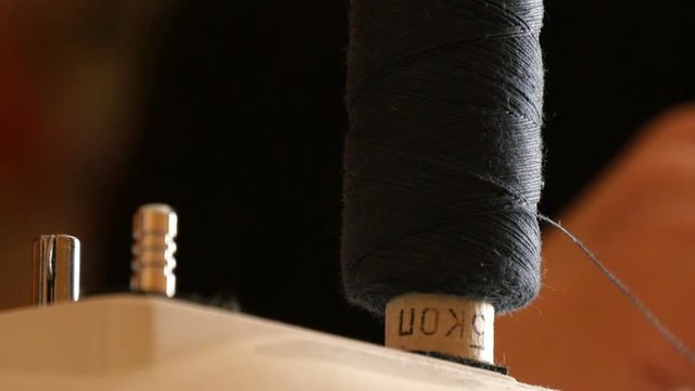  spool of sewing thread on the sewing machine, close-up