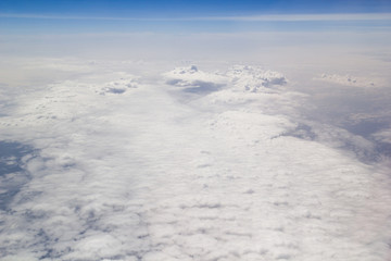 Fototapeta na wymiar Clouds carpet blue skyand horizon from above