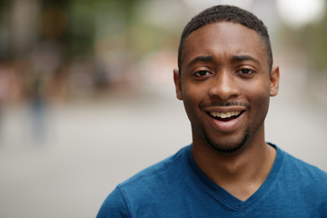 Young black man in city shocked face portrait