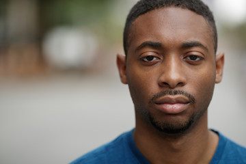 Young black man in city serious angry face portrait