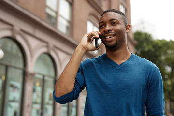 Young man in city talking on cell phone
