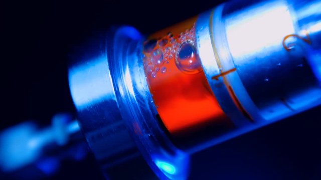 Addict injects heroin or meth by syringe into a vein on black background. Macro