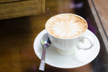 cup of coffee on old wooden desk. Simple workspace or coffee bre