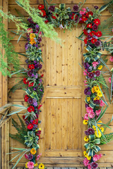 Fototapeta na wymiar Wooden door decorated with flowers