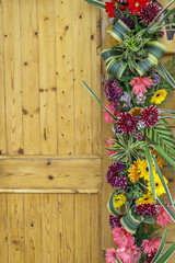 Side of wood door decorated with flowers
