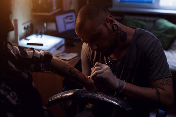 Tattooer makes tattoo for woman