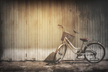 Obraz na płótnie Canvas vintage bicycle on vintage wooden house wall