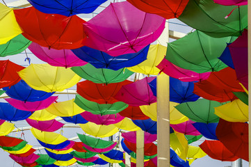 Fototapeta na wymiar Multicolored umbrellas reversed hanging