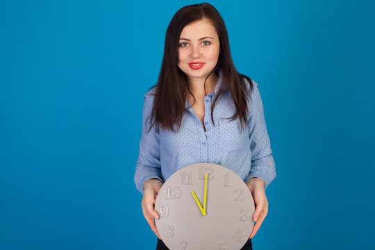 Cute woman in blue with clock