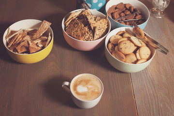 Plates with cookies and cuo on table