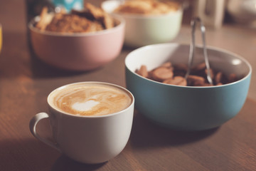 On the table cup and different cookies