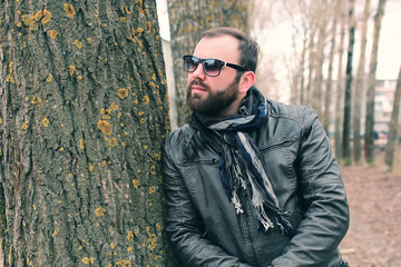 Fototapeta na wymiar beard man in park with headphon