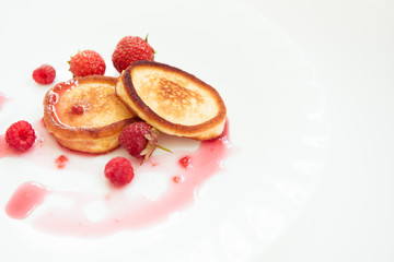 Pancakes on the white plate with raspberry jam