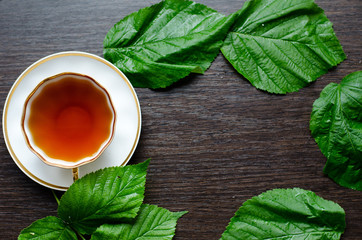 natural herbal antipyretic -organic raspberry leaves tea

in a white porcelain сup with fresh...