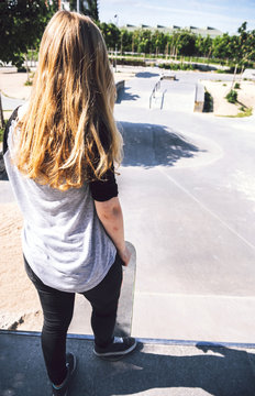 Skateboarding woman practicing at skatepark