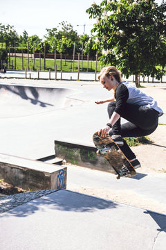 Skateboarding woman practicing at skatepark
