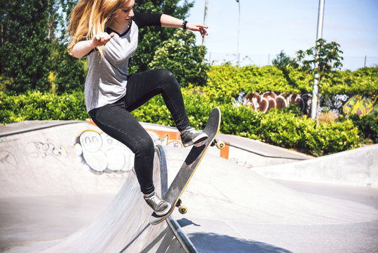 Skateboarding woman practicing at skatepark