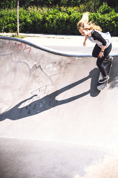 Skateboarding woman practicing at skatepark