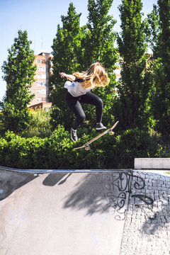 Skateboarding woman practicing at skatepark