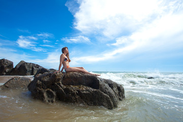 Woman on the rock in ocean