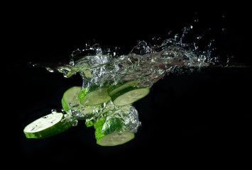 Sliced cucumber splashing water