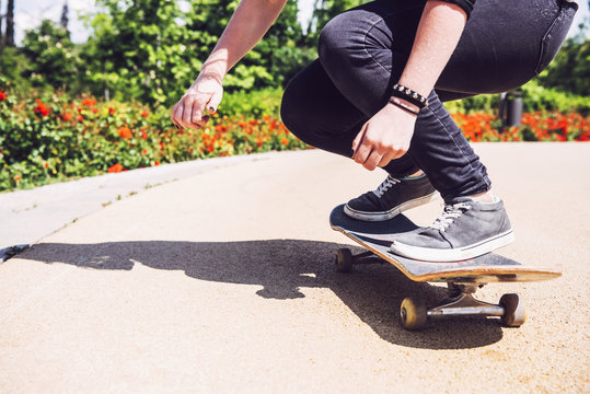 Skateboarder woman practicing ollie at park