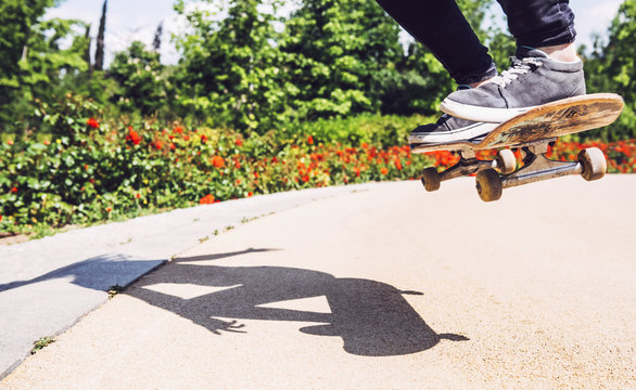 Skateboarder woman practicing ollie at park