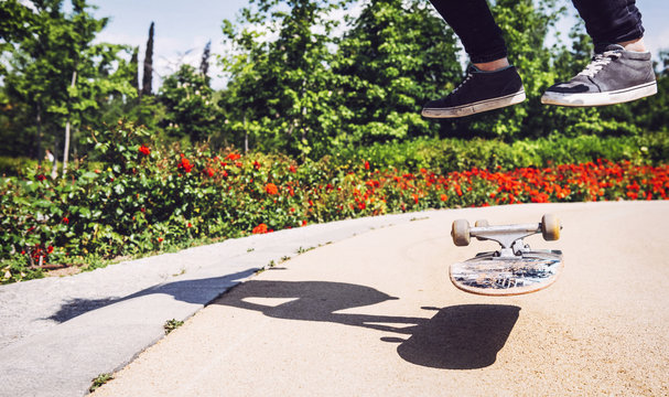 Skateboarder woman practicing ollie at park