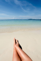 Legs of young woman on the beach