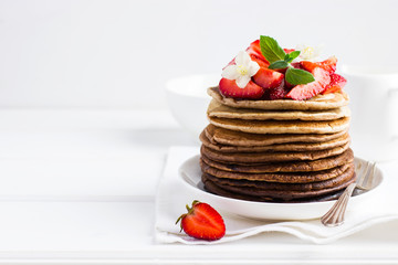 Ombre chocolate pancakes with fresh strawberry on white backgrou