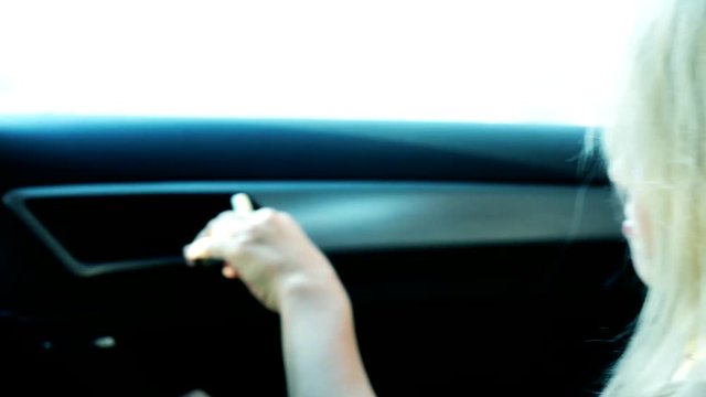 little powerless frightened girl sits in the locked car - she try open the door - close up 