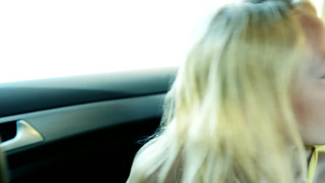 little scared girl is locked in the car - she try open the door - she looks around herself - kidnap - close up
